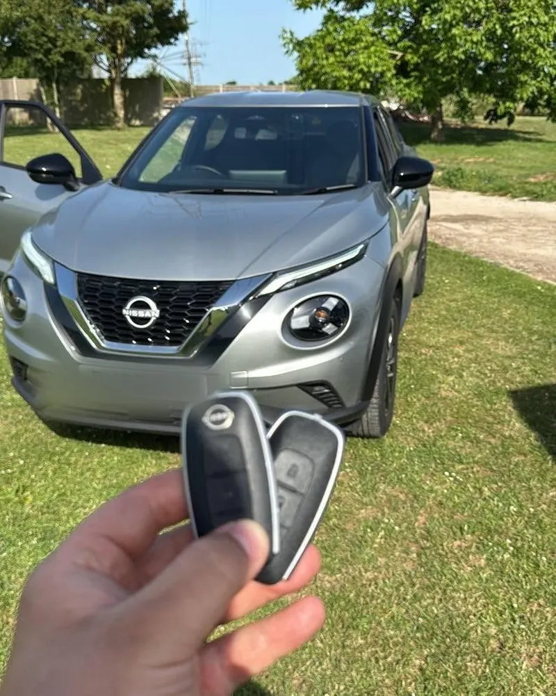 Replacement smart key programmed for a Nissan Juke on a driveway
