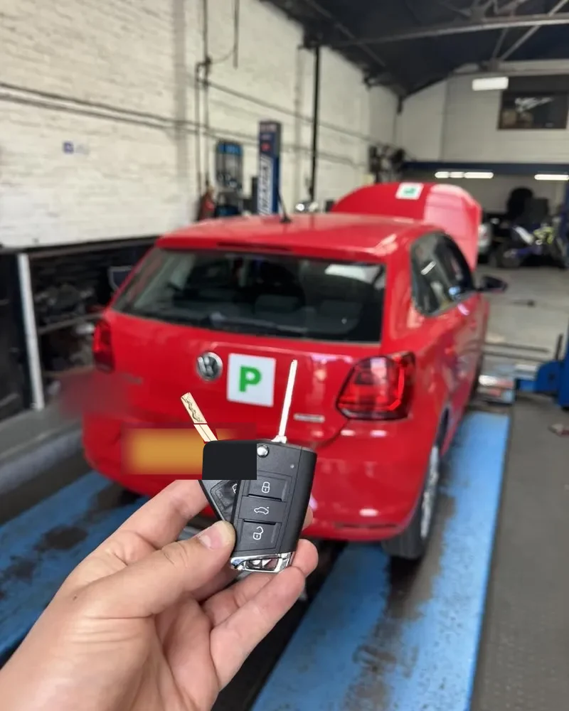 Flip key cut and coded for a red VW Polo